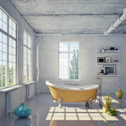 Nowoczesna łazienka - wanna w mocnym kolorze, wśród surowych, betonowych ścian i podłóg prezentuje się wyjątkowo!fot. fotolia